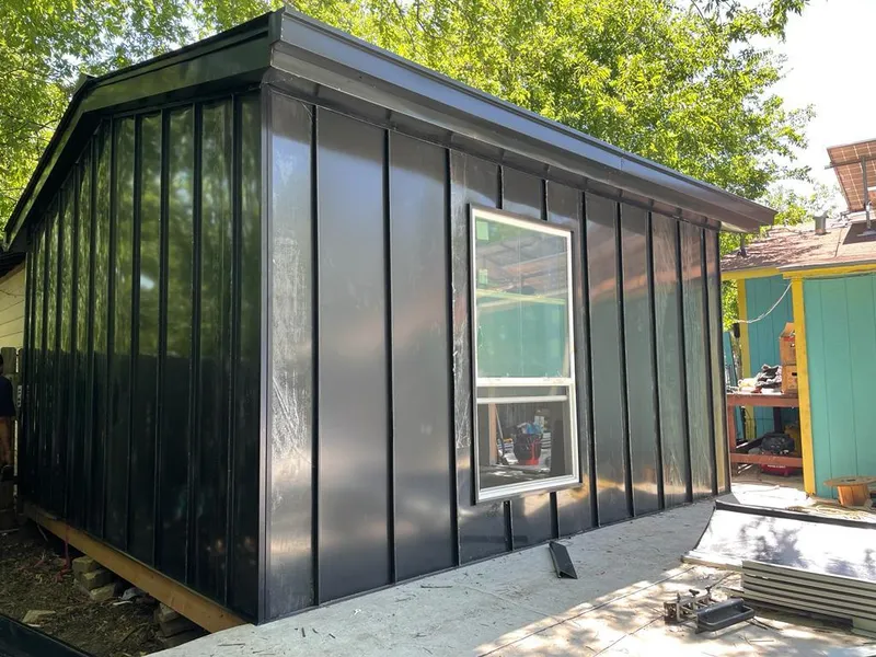 Black standing seam metal wall panels for Roof Inspection in St. Stephens